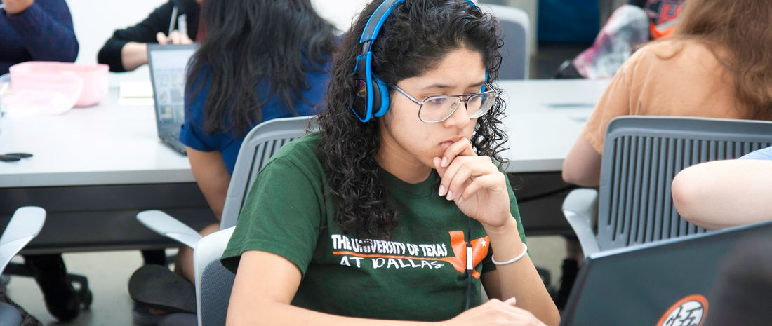 Student wearing headphones practising on a laptop ahead of a GCSE language listening exam